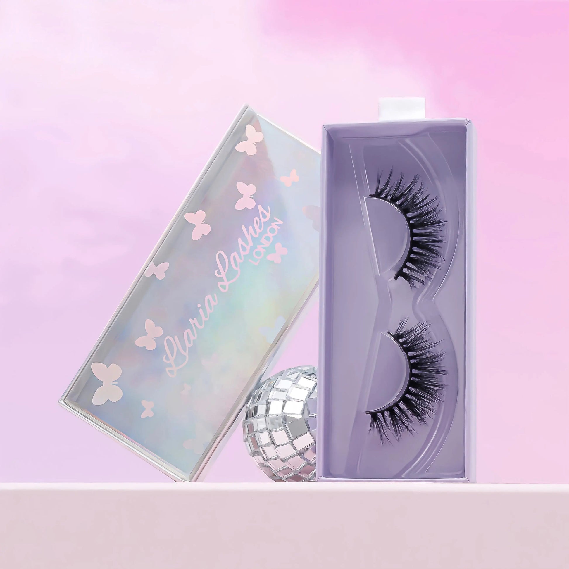 Eyelashes in a branded box on a pink background