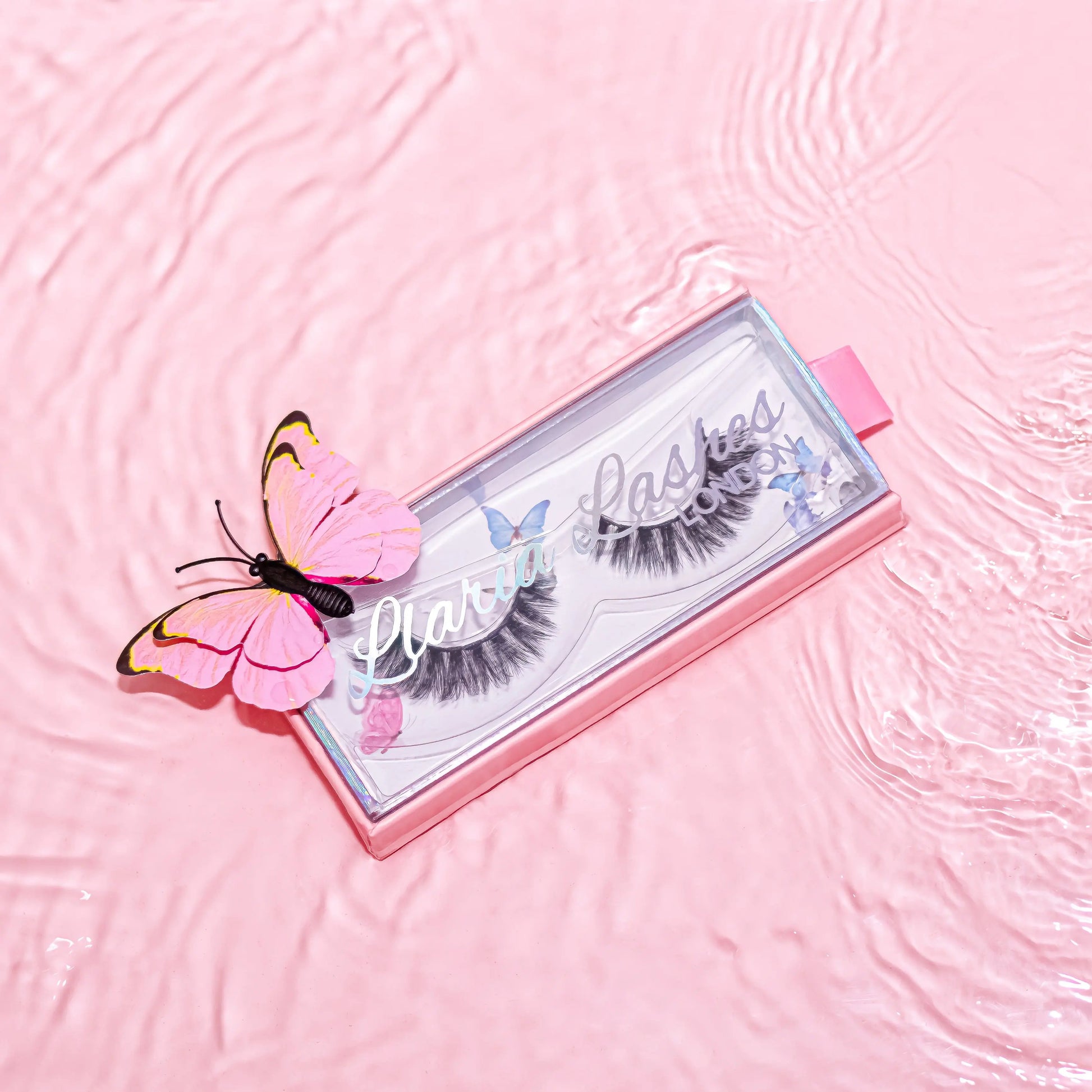 Eyelash packaging with a pink butterfly on a pink textured background