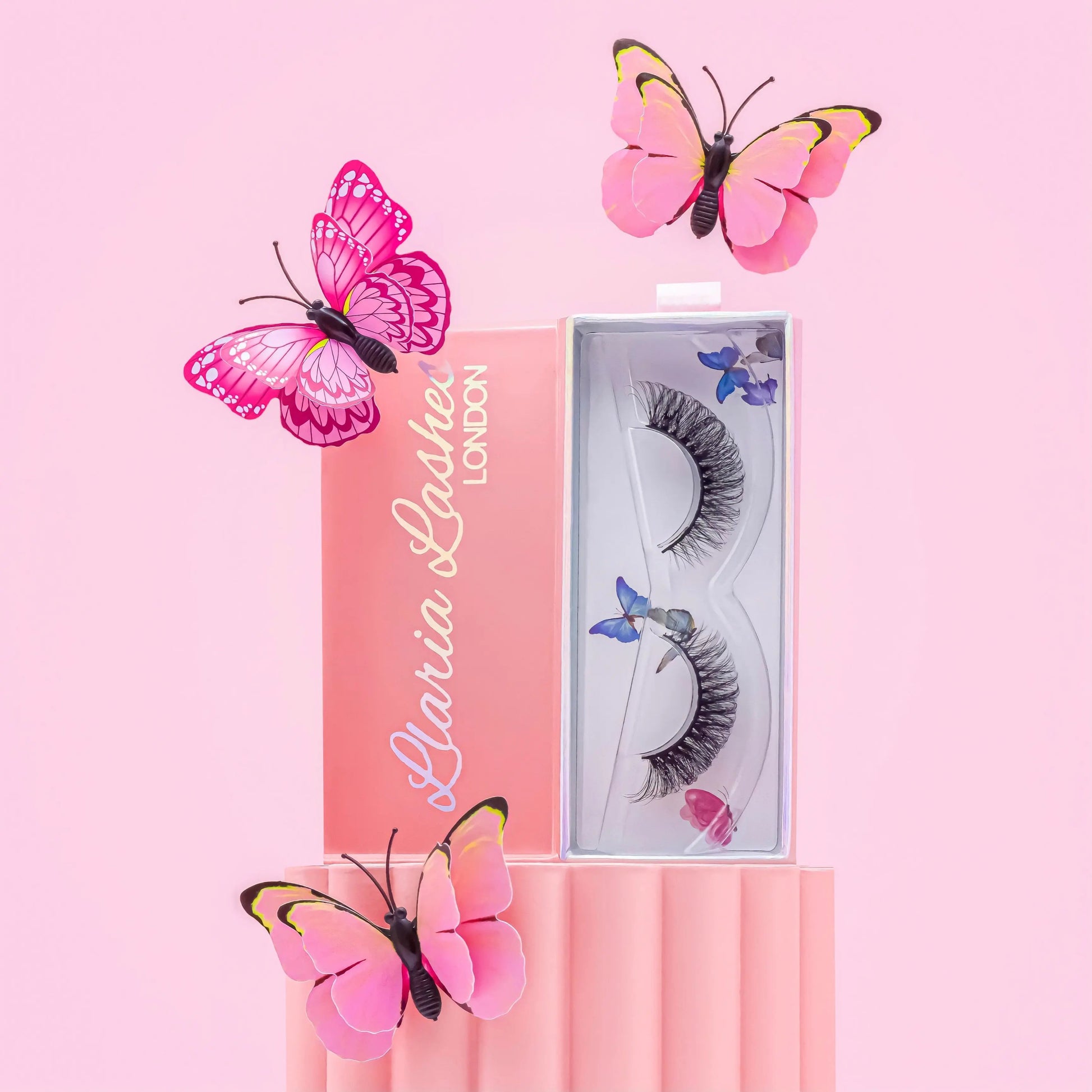 Eyelashes in a decorative box with pink butterflies on a pink background