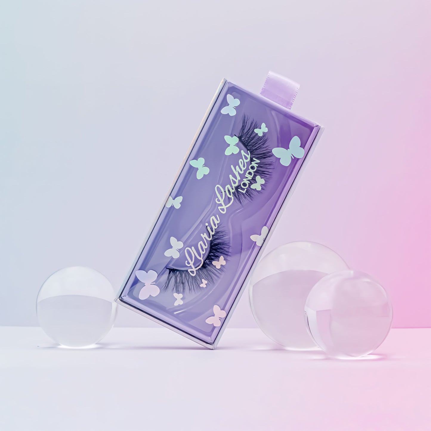 Eyelash packaging with butterfly designs on a gradient background