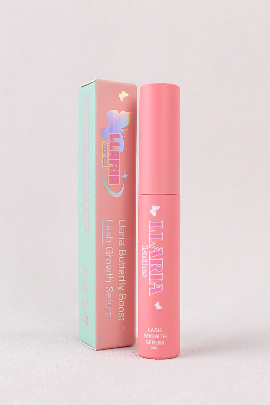 Pink lip balm with packaging on a light gray background