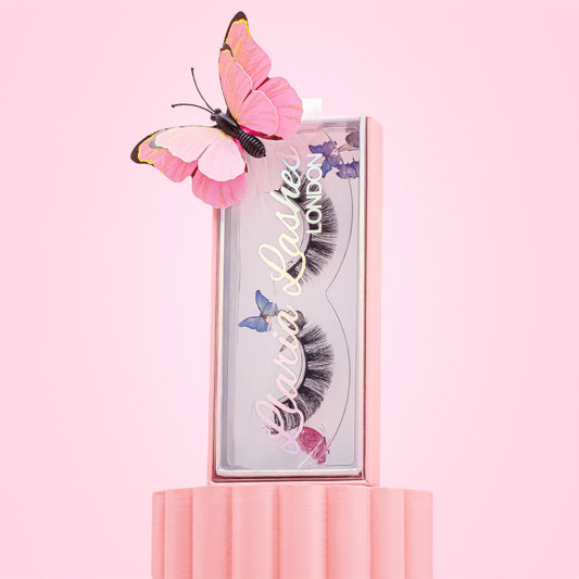 Miu Miu Lashes packaging with butterfly decorations on a pink background