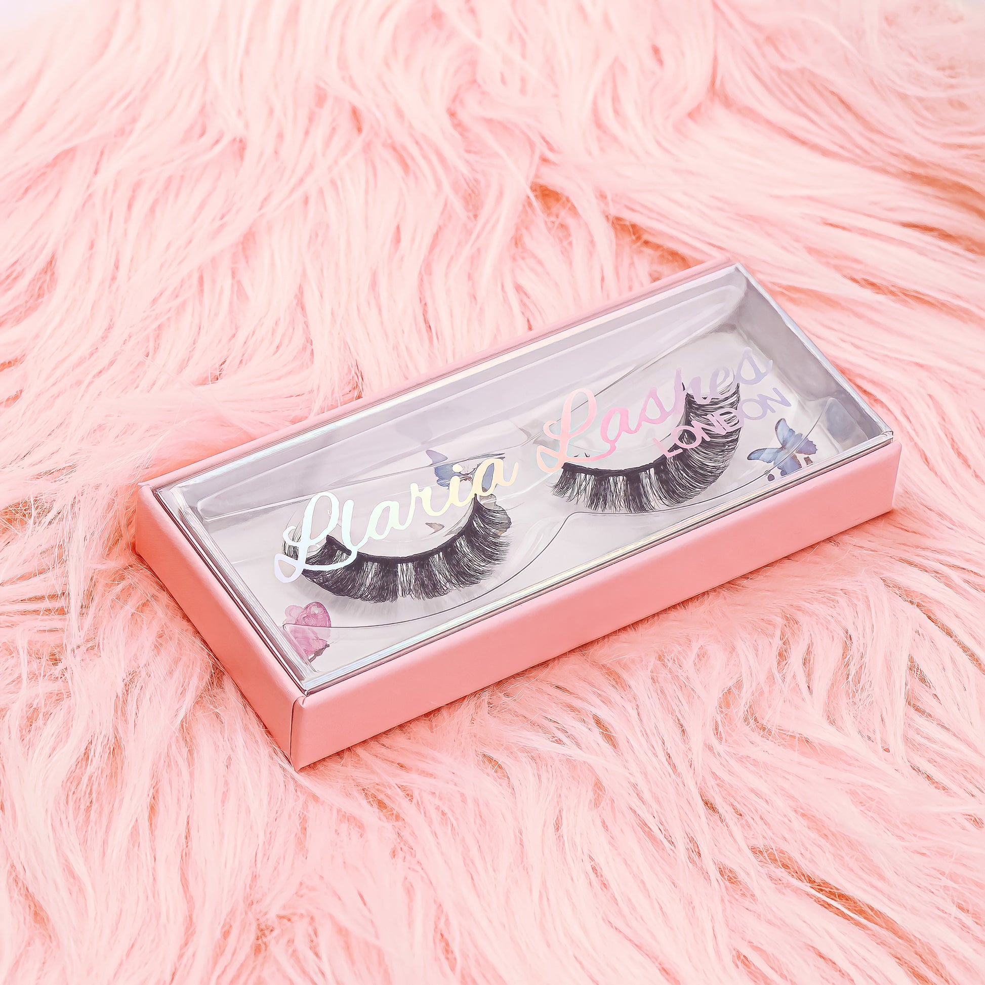 Eyelashes in a pink box on a pink fluffy background