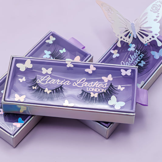 Eyelash packaging with butterfly designs on a light purple background
