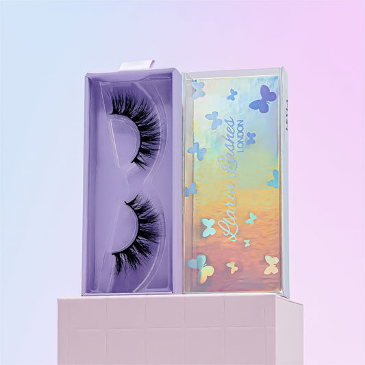 Eyelash packaging with a colorful butterfly design on a light purple background