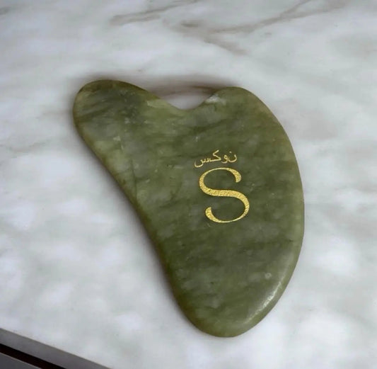 Natural jade gua sha facial sculpting tool by Llaria Beauty for lymphatic drainage and facial massage