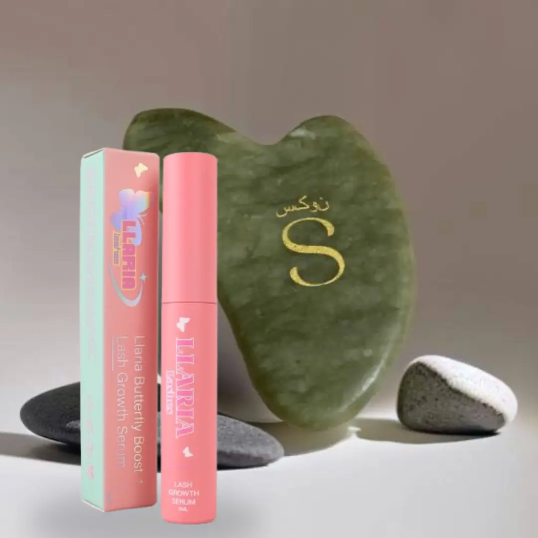 Pink lip balm with packaging and a green stone on a neutral background