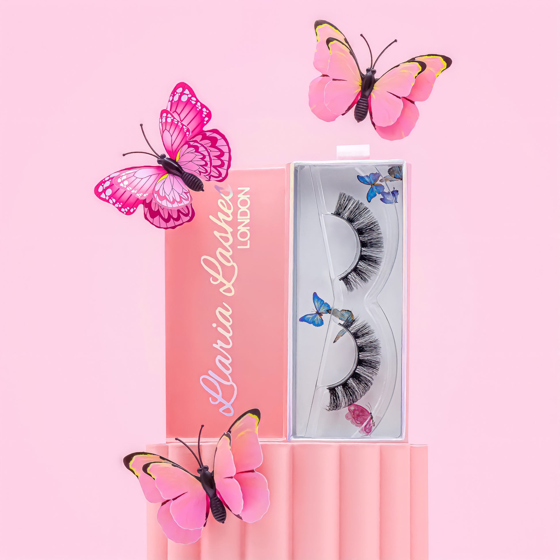 Eyelash packaging with decorative butterflies on a pink background