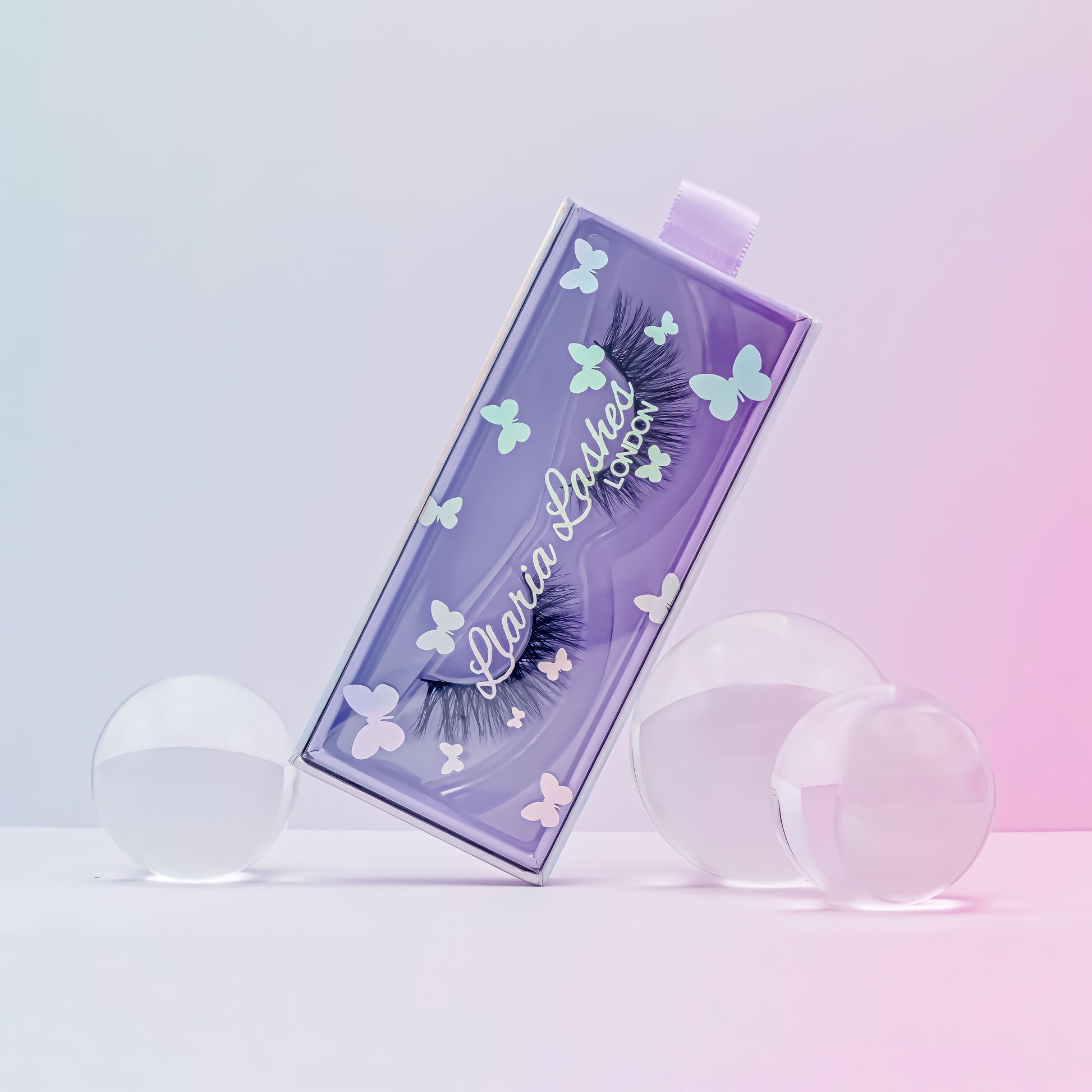 Eyelash packaging with butterfly designs on a gradient background