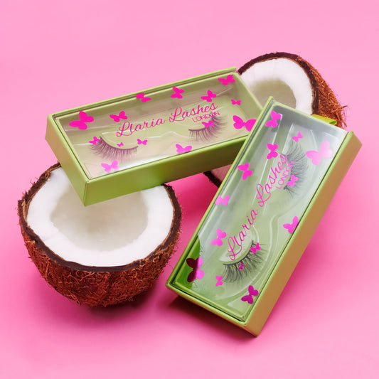 Green box with eyelashes and pink butterflies on a pink background